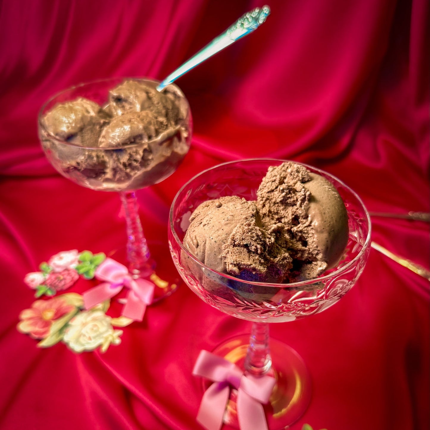 Two glass dishes with chocolate espresso ice cream on a red fabric background