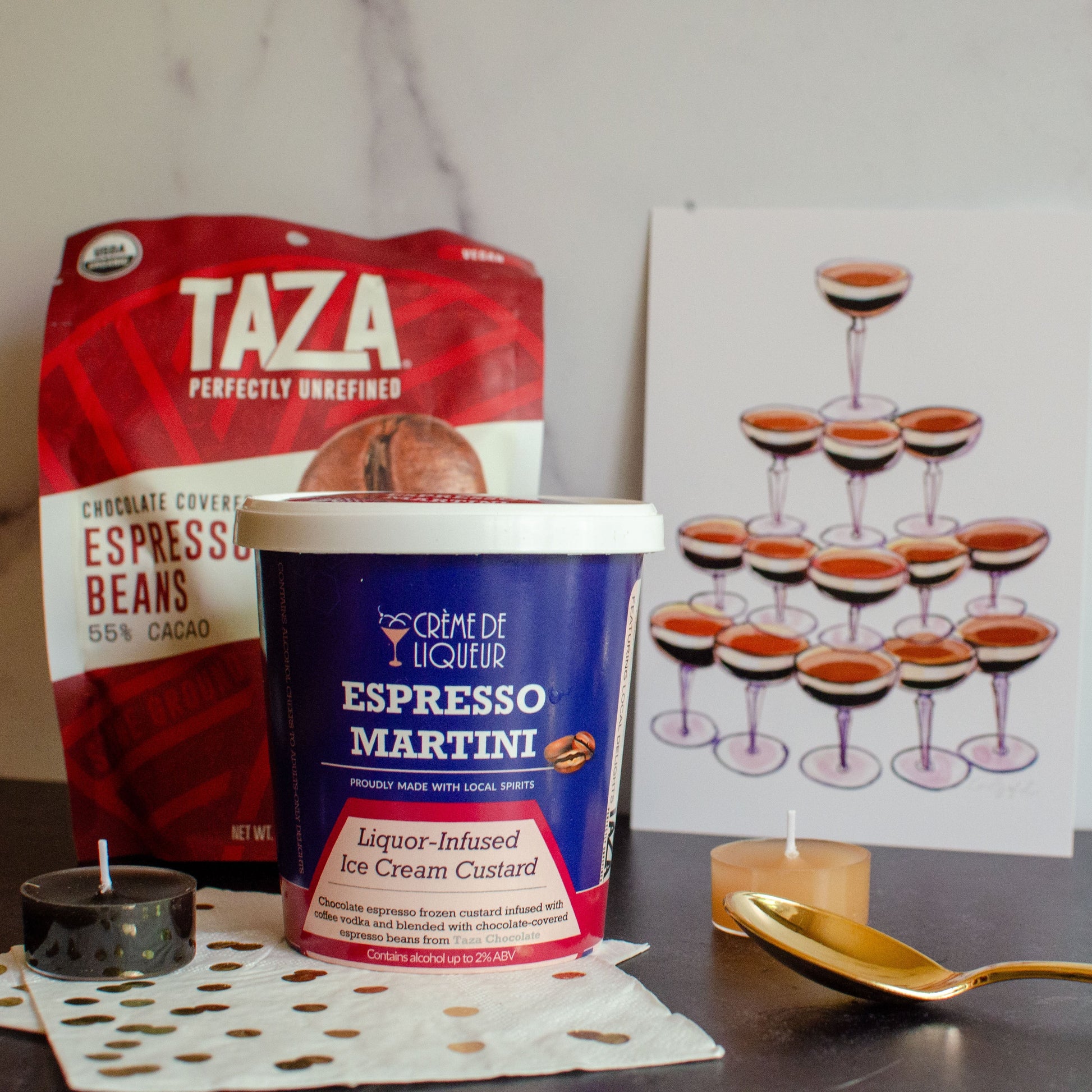 Taza espresso beans and Creme de Liqueur Espresso Martini on a table with a glass tower illustration in the background.